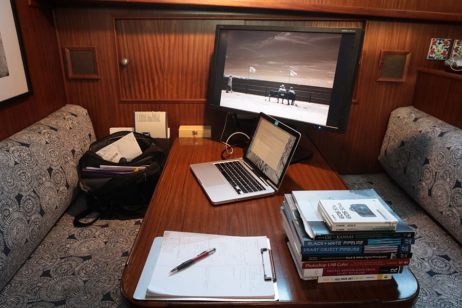 Boat Dinette with Computer, Large Monitor with Photo Dispayed and Photo Books.